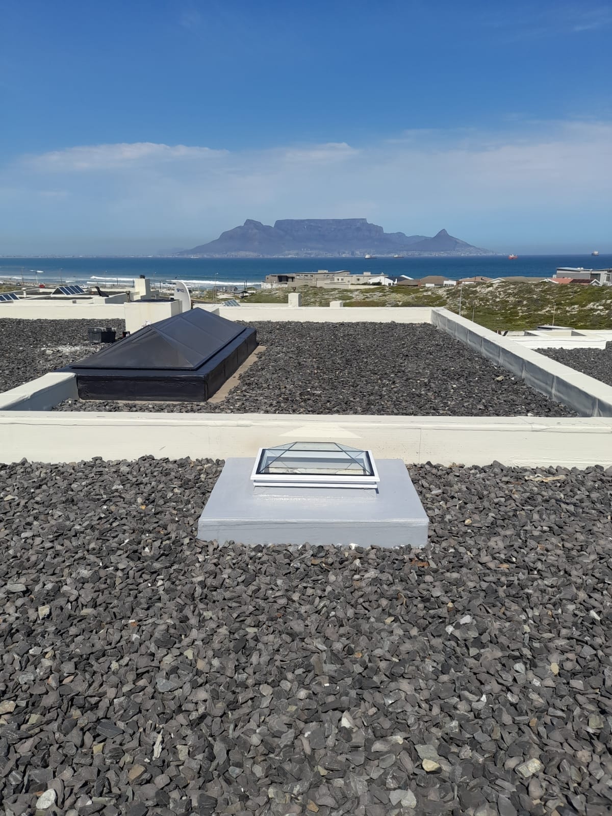 Rooftop skylight installation with iconic Table Mountain in the background