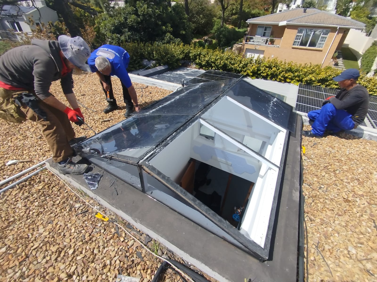 Three skylights installed on a white corrugated roof